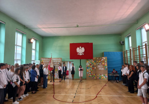 Uczniowie w sali gimnastycznej podczas uroczystości